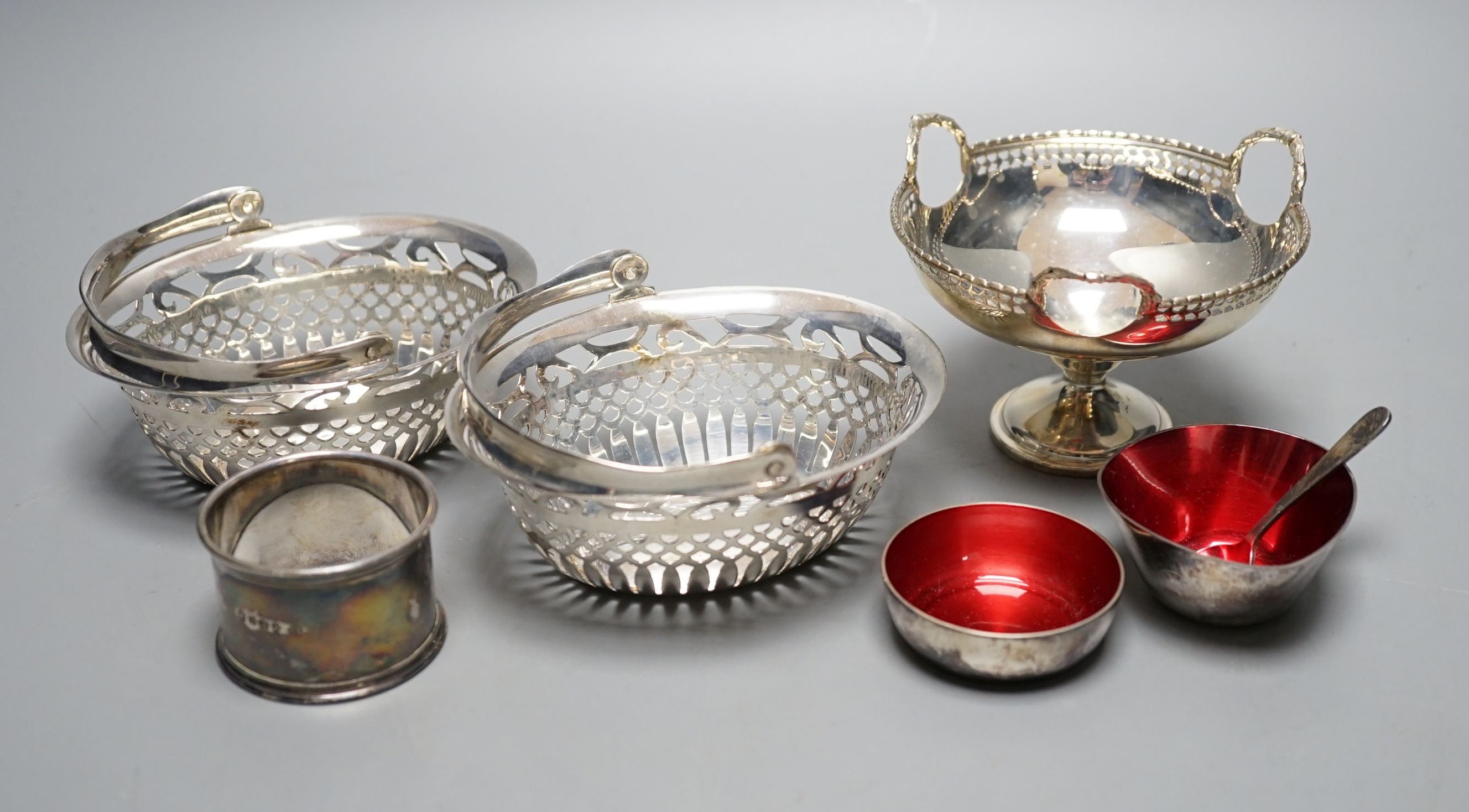 A pair of George V pierced silver bonbon baskets, a small pedestal bowl and napkin ring and two small Danish enamelled bowls.